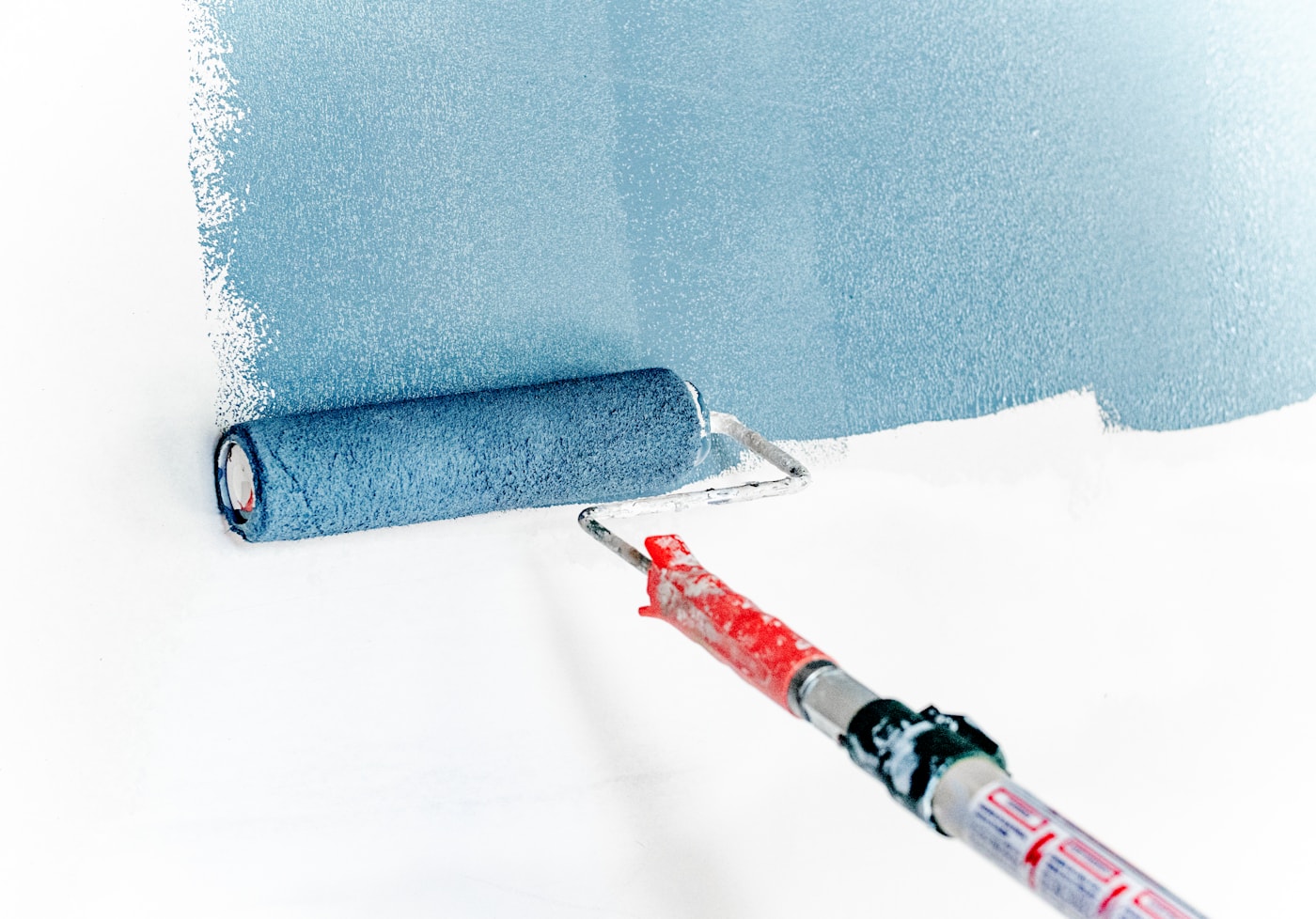 Painter working carefully with vivid wall color